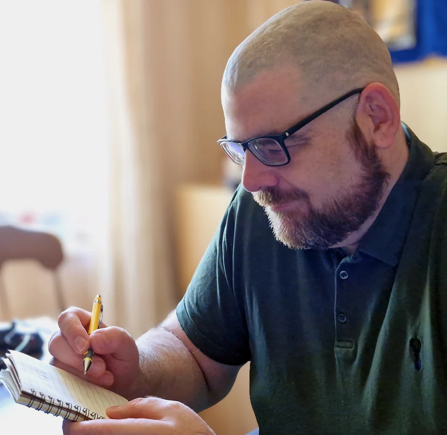 Sean writing in a notebook